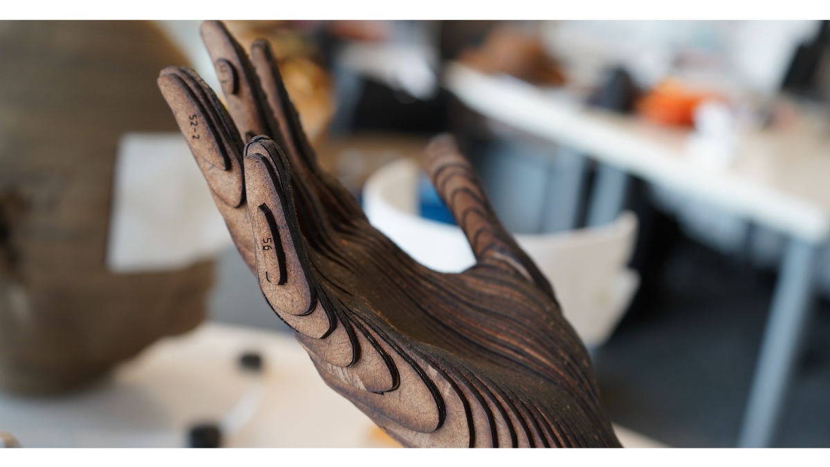 A laser-cut wooden hand made by a student.