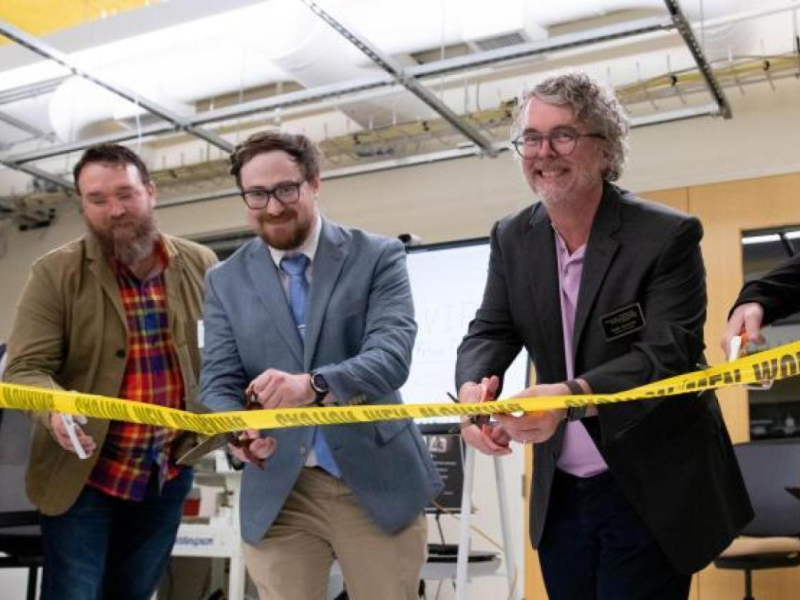 Group of professors at a cord-cutting celebration inaugurating the new Craft Lab.