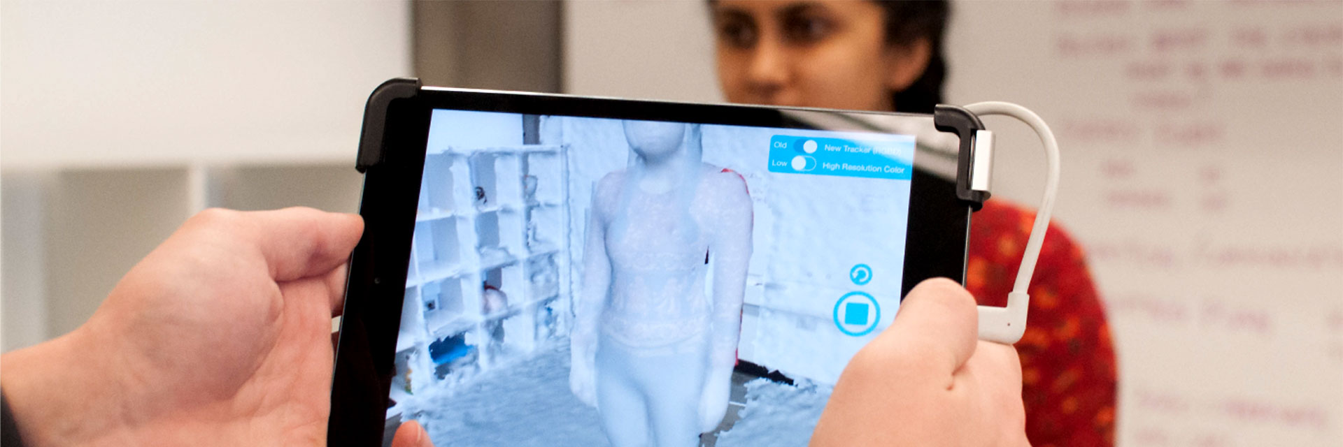 person being digitally scanned and appearing on an iPad