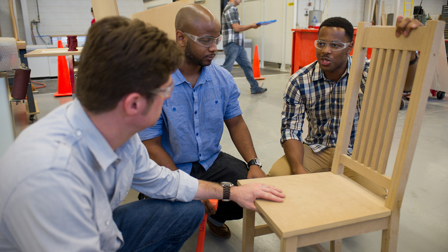 Donald Burlock, a fellow student, and Kevin Shankwiler work on a chair in 2011.