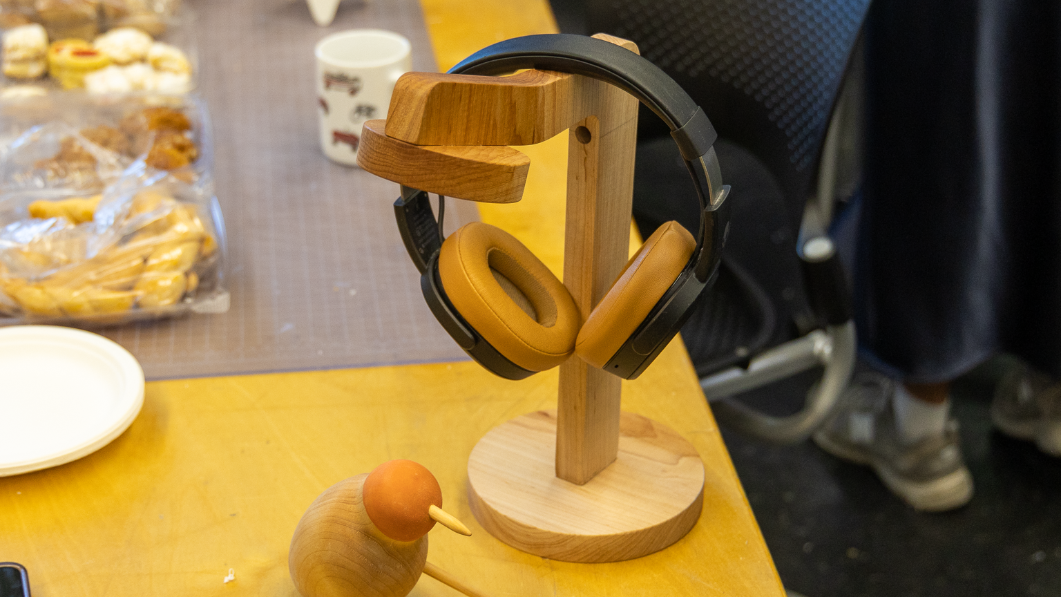 A desktop holder for headphones, with an integrated lamp