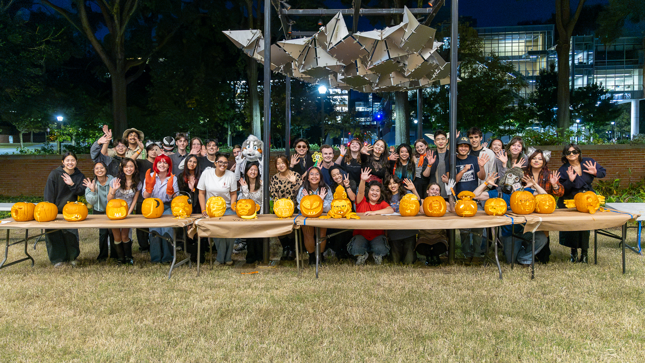 Participant pose with finished pumpkins 