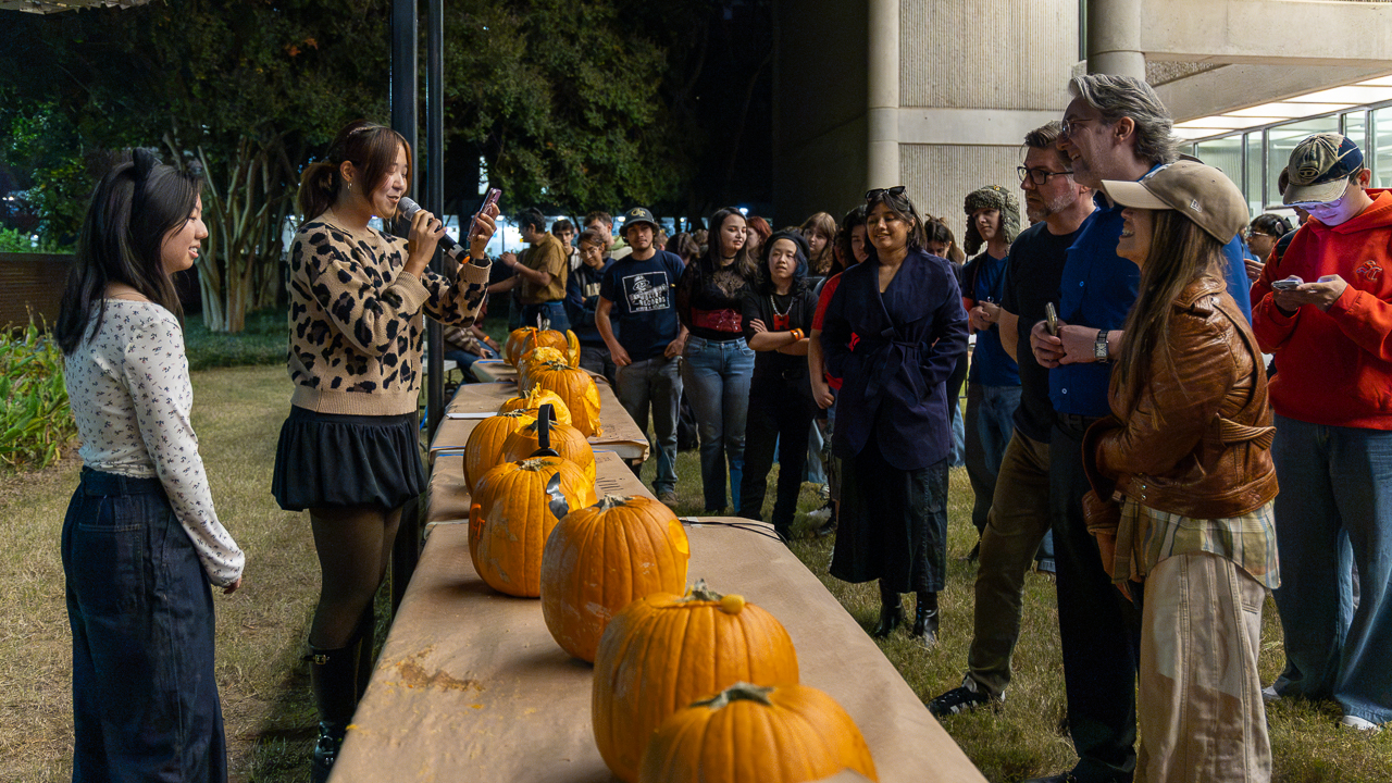 Judges look at the pumpkins as students explain thier design 