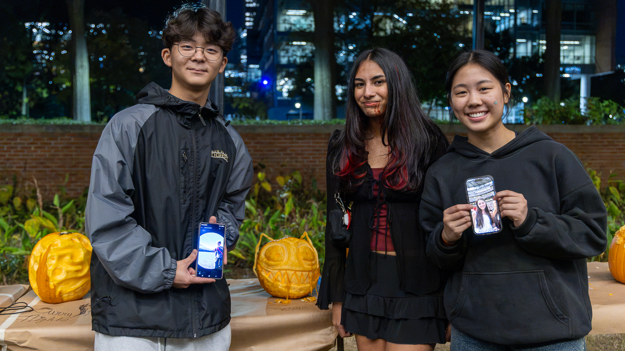 Three of the four winners pose with their Rotting Buzz pumpkin design